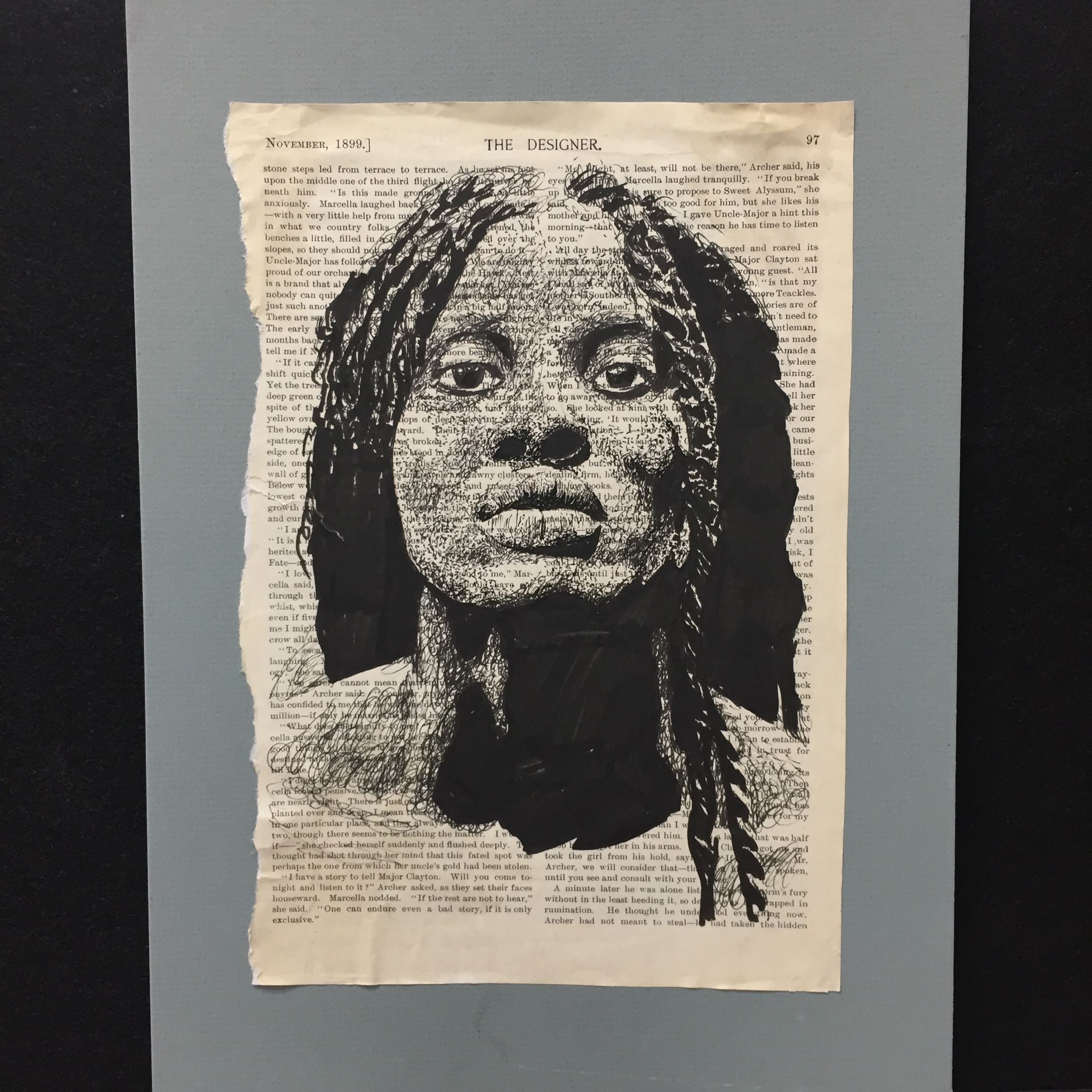 Black and white sketch of woman's face on printed text